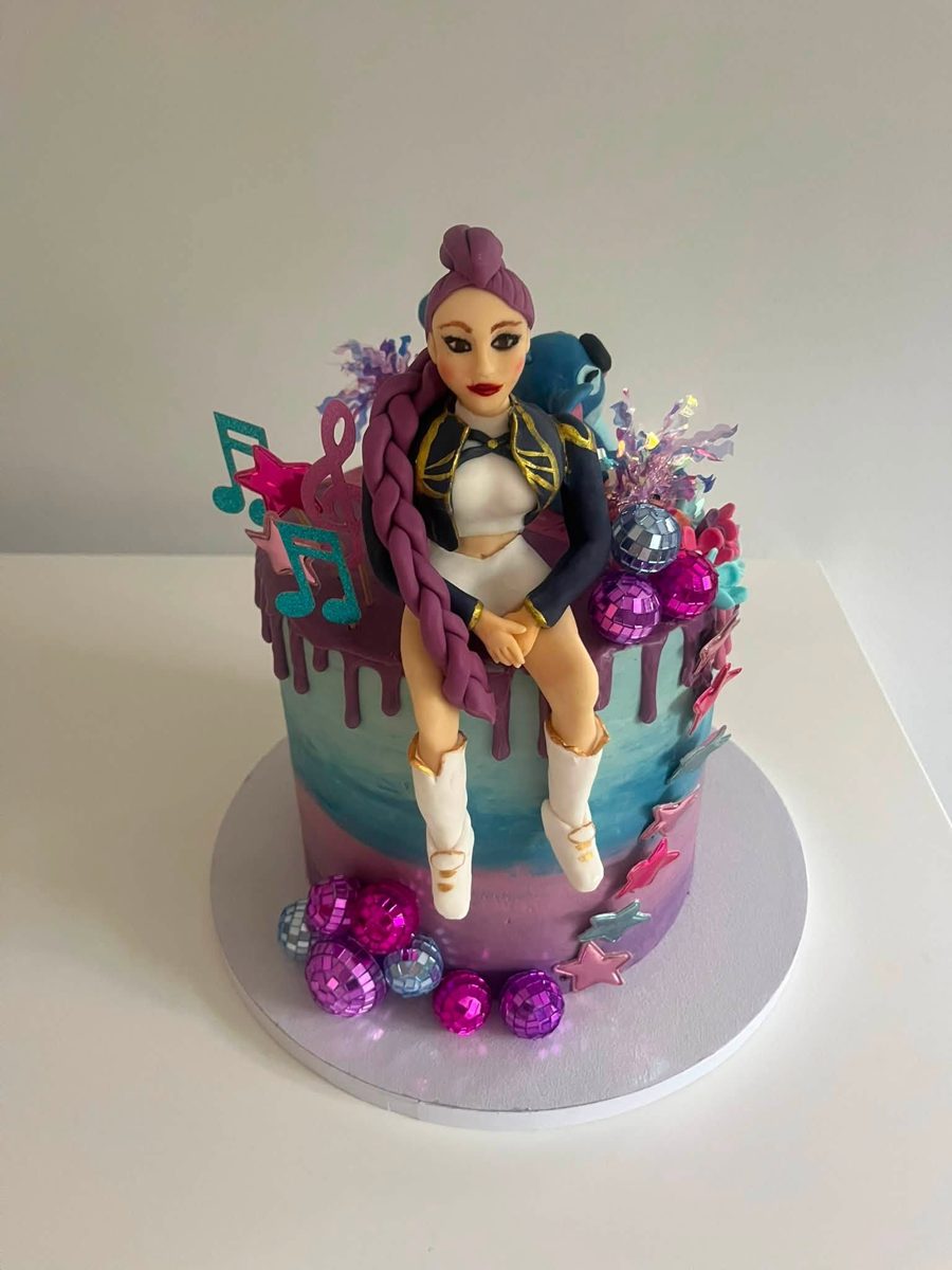 Character cake topped with a hand-modelled figure, with drip icing, music notes and disco balls