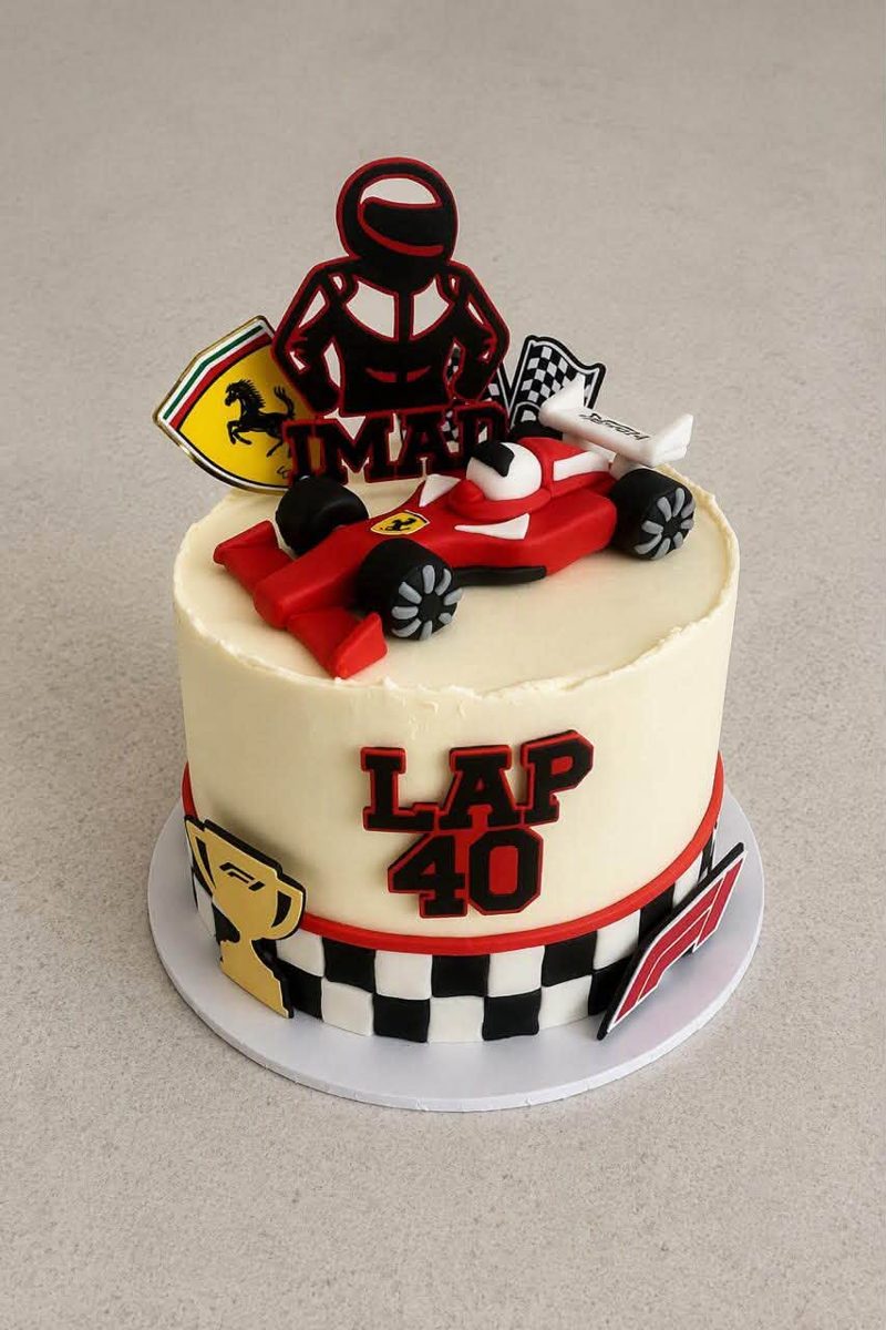 Motor racing themed birthday cake with a model racing car and chequered flag